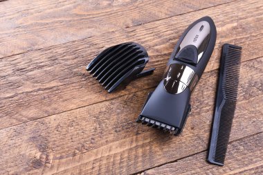 Hortumlu budayıcı. Yeni bir kablosuz budayıcı alıyorum. Ahşap bir arka planda. Yakın plan. Metin için bir boşluk ile