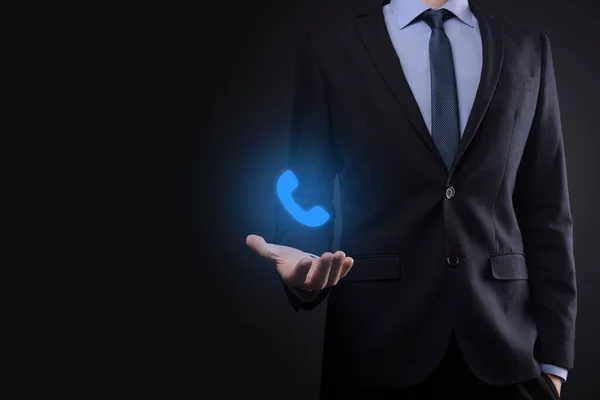 Businessman man in suit on black background hold phone icon.Call Now Business Communication Support Center Customer Service Technology Concept