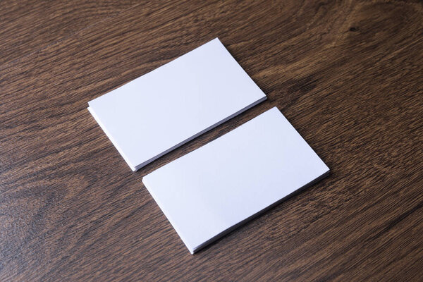 Business card blank on wooden background. Corporate Stationery, Branding Mock-up. Creative designer desk. Flat lay. Copy space for text. Template for ID