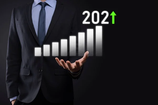 Business development to success and growing growth year 2021 concept.Plan business growth graph in year 2021 concept.Businessman plan and increase of positive indicators in his business.