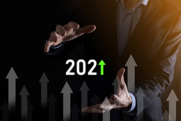Business development to success and growing growth year 2021 concept.Plan business growth graph in year 2021 concept.Businessman plan and increase of positive indicators in his business.