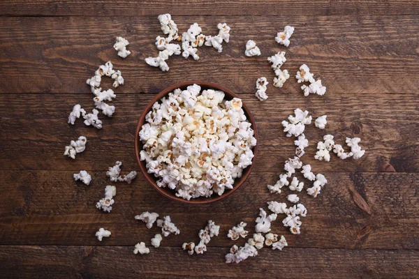 Popcorn in bowl on a red background. Close up. Top view.