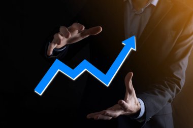 İş adamı artan ekran grafiği, pozitif büyüme ikonu okları üzerinde duruyor. Yaratıcı iş grafiğine yükselen oklarla işaret ediyor. Finansal, ticari büyüme kavramı.