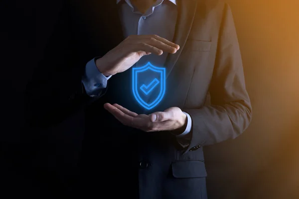 Protection network security computer in the hands of a businessman. business, technology, cyber security and internet concept - businessman pressing shield button on virtual screens Data protection.