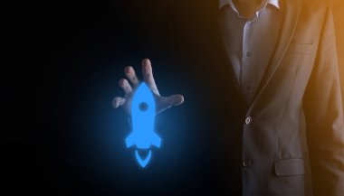 Girişim konsepti, Tablet ve simge roketi tutan İşadamı ekrandan koyu arkaplanda ağ bağlantısı ile fırlıyor ve yükseliyor