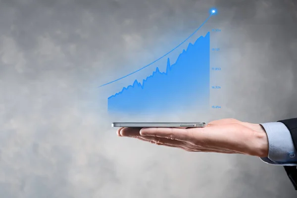 Businessman holding graph growth and increase of chart positive indicators in his business.Investment up concept.analyzing sales data and economic,strategy and planning, Digital marketing and stock market.