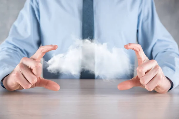 Businessman hand holding cloud.Cloud computing concept, close up of young business man with cloud over his hand.The concept of cloud service