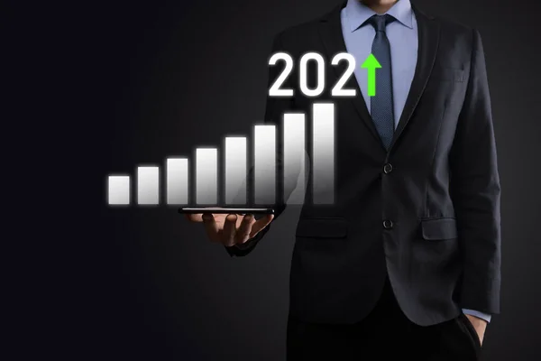 Business development to success and growing growth year 2021 concept.Plan business growth graph in year 2021 concept.Businessman plan and increase of positive indicators in his business.