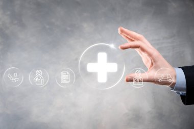 İş adamının elinde sanal ve tıbbi ağ bağlantısı simgeleri var. Covid-19 salgını insanları bilinçlendirir ve sağlık hizmetlerine dikkat çeker. Doktor, belge, ilaç, ambulans, hasta ikonu