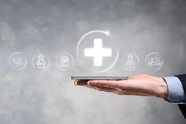 Businessman hold virtual plus medical network connection icons. Covid-19 pandemic develop people awareness and spread attention on their healthcare.Doctor,document,medicine,ambulance,patient icon