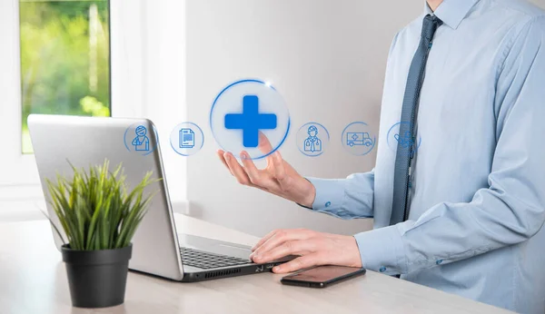 Businessman hold virtual plus medical network connection icons. Covid-19 pandemic develop people awareness and spread attention on their healthcare.Doctor,document,medicine,ambulance,patient icon