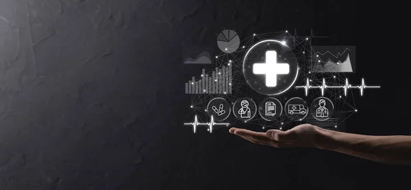 Businessman hold virtual plus medical network connection icons. Covid-19 pandemic develop people awareness and spread attention on their healthcare.Doctor,document,medicine,ambulance,patient icon