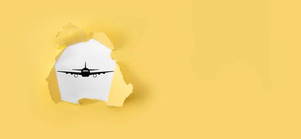 Torn yellow paper with plane airplane icon on blue background. Banner.nline ticket purchase.Travel icons about travel planning, transportation, hotel, flight and passport.Flight ticket booking concept