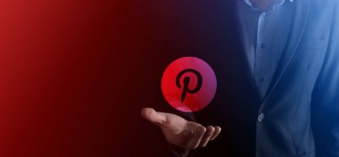 Onok, Ukrayna - 14 Temmuz 2021: İşadamı elinde tutuyor, tıklıyor, pinterest simgesi avucunun içinde. Sosyal ağ. Küresel ağ ve veri müşteri bağlantısı. Uluslararası ağ