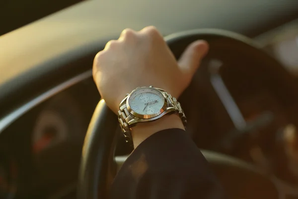 O homem ao volante o carro, mão com relógios — Fotografia de Stock