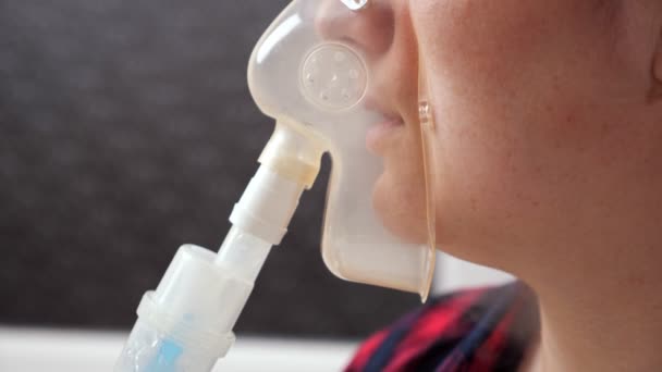 Close-up of inhalation mask on young womans face — Stock Video