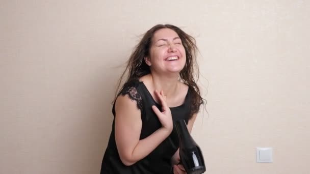 Happy young woman holds modern hair dryer in hand and dries dancing and singing in bathrobe — Stock Video