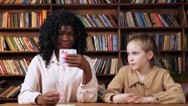 Individuele leraar geeft les aan schoolmeisjes brieven met flashcards — Stockvideo