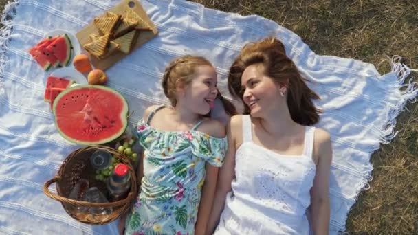 Lycklig mor rör dottern näsa liggande på picknick filt — Stockvideo