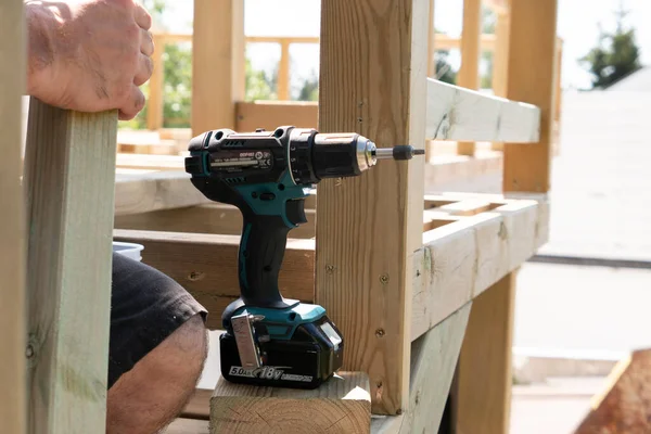 Close up of a carpenter with drilling machine construction tool