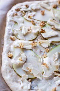 Çiğ pizza, armut, peynir ve ceviz. Çeşitli vejetaryen pizzaları. Evde yemek pişirmek..