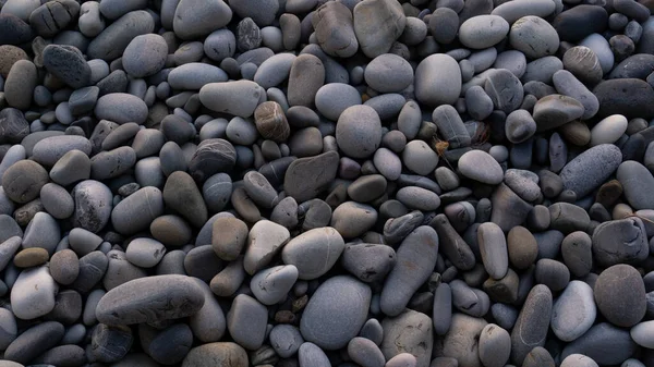 Fundo de pedras marinhas com pequenos seixos ou pedra no jardim ou à beira-mar ou em uma praia. Uma vista de perto de pedras de seixos polidas lisas arredondadas — Fotografia de Stock