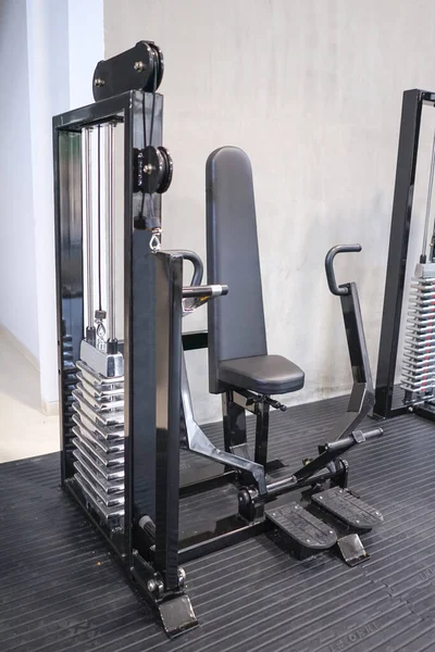 Gym with modern fitness equipment for fitness body workout.
