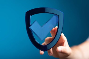 Güvenlik konsepti işaretli mavi kalkana dokunuyor