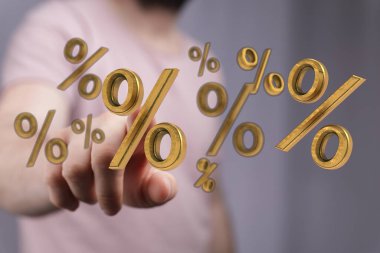 Kişi, finans anlaşmaları için altın yüzde sembollerine işaret ediyor