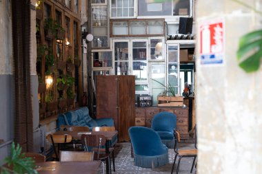 Mavi kadife sandalyeli ve ahşap mobilyalı bir köy kafesi.