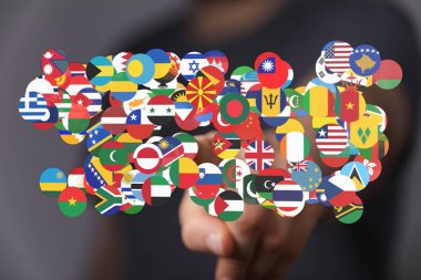 Ülkeleri temsil eden çeşitli Dünya Bayrakları ve küresel bağlantı el teması