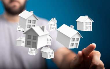 Küçük beyaz evleri işaret eden kişi, emlak konsepti