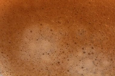 Kahverengi kremalı ve köpüklü kahve. Yiyecek ve içecek geçmişi için mükemmel..