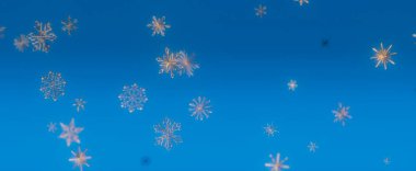 Mavi zemin üzerinde beyaz kar tanelerinin yakın çekim görüntüsü kışın festival sahnesi yaratır..