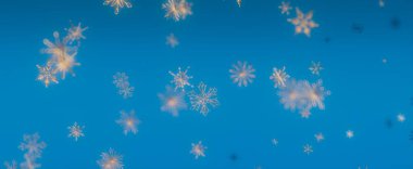 Parlak mavi gökyüzüne düşen kar tanelerinin güzel bir görüntüsü, mükemmel bir kış manzarası..