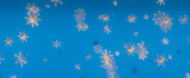 Düşen kar tanelerinin canlı mavi bir arkaplana yakın plan görüntüsü. Narin kar taneleri kışın güzelliğini ve harikalığını simgeleyen büyüleyici bir görüntüdür..