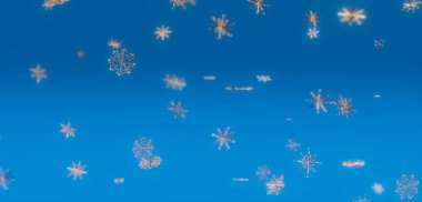 mavi zemin üzerine düşen kar taneleri