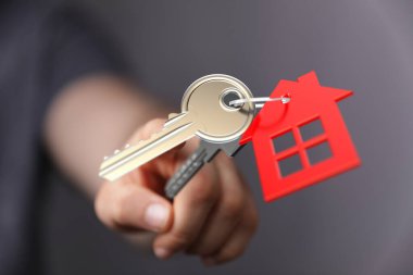 Ev anahtarı, kırmızı ev anahtarlığı, emlak konsepti.