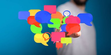 Adamın eli yüzen renkli konuşma baloncuklarına uzanıyor.