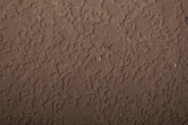 Kalıplaşmış kahverengi yüzey, kaba detayları ve doğal desenleri gösteriyor