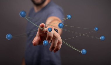 Birbirine bağlı kürelere dokunmak bir ağı temsil eder.