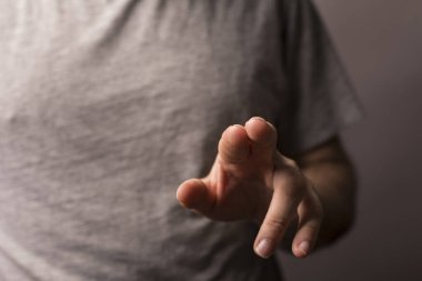 Adamın eli ileri uzanıyor yumuşak ışıkta izole edilmiş bir şekilde.