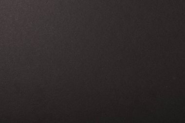 Koyu dokulu arka plan, ince taneli detaylar ve nötr tonlar.