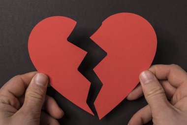 Kırık bir kalbi tutan eller ilişki sorunlarını simgeliyor.