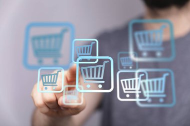 Man touching shopping cart icons: Online shopping, ecommerce concept