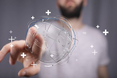 İnsanlar dijital küreye dünyanın birbirine bağlılığını simgeleyen artı işaretlerle dokunuyorlar.