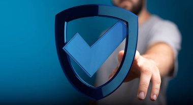 Adamın elinde güvenlik ve korunma işaretli dijital bir kalkan var.