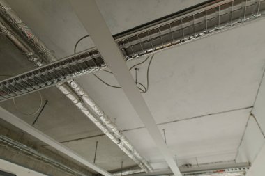 Modern Office Ceiling with Exposed Pipes and Lighting
