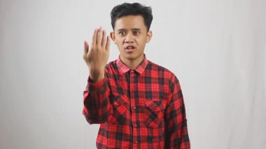 Kırmızı kareli gömlek giyen Asyalı bir adam arkadaşını arayıp buraya gelmesini söylemiş.