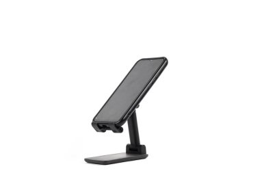 Siyah akıllı telefon siyah bir standa monte edilmiş, parlak beyaz bir arka planda izole edilmiş..